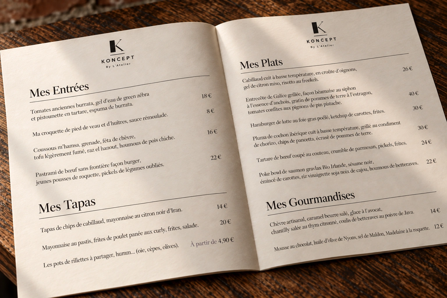 Carte KONCEPT ouverte : entrées, tapas, plats et gourmandises, filets fins et prix alignés. Burrata, cabillaud et entrecôte de Galice figurent au menu.
